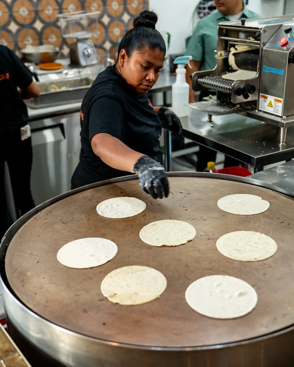 Woman preparing fresh tortillas using authentic recipes